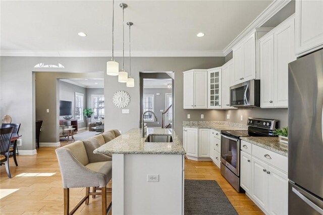 1241 Newbury Highland, South Fayette, PA 15017 - kitchen with appliances with stainless steel finishes, a sink, a kitchen bar, crown molding, and glass insert cabinets