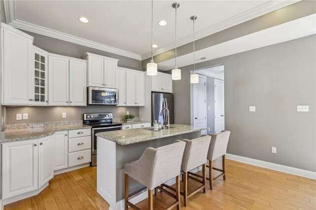 1241 Newbury Highland, South Fayette, PA 15017 - kitchen featuring stainless steel appliances, a sink, crown molding, light wood-type flooring, and white cabinets