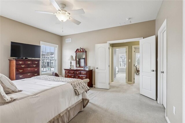 1241 Newbury Highland, South Fayette, PA 15017 - bedroom with multiple windows, light colored carpet, a ceiling fan, and baseboards