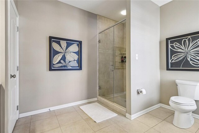 1241 Newbury Highland, South Fayette, PA 15017 - bathroom featuring tile patterned flooring, a stall shower, toilet, and baseboards