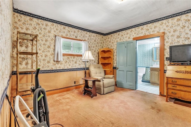living area featuring wallpapered walls and carpet floors