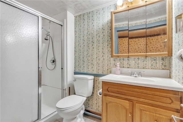 bathroom with wallpapered walls, a stall shower, toilet, and vanity