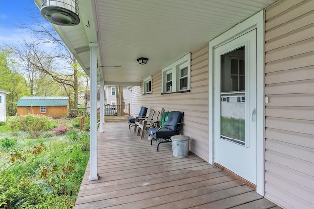 wooden deck with an outbuilding