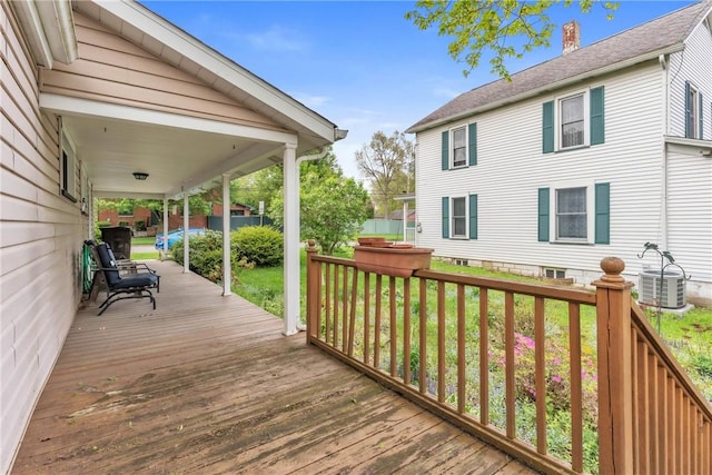 deck featuring central AC unit and a lawn
