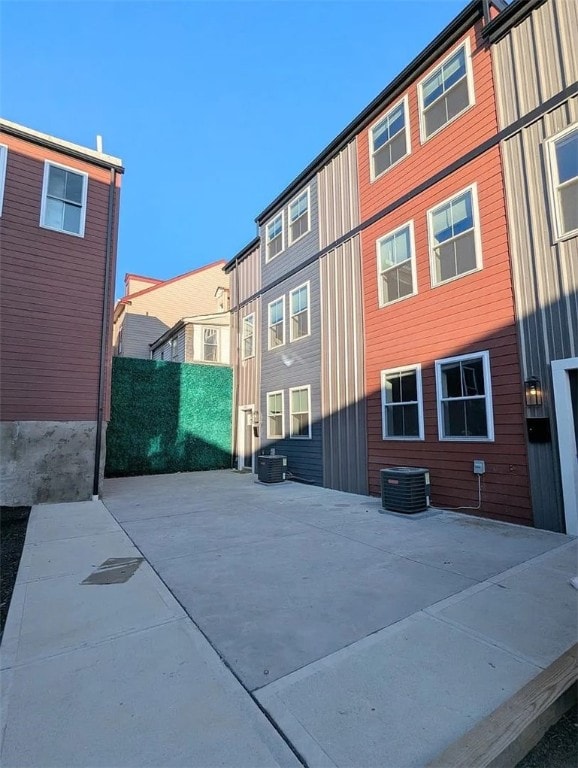 rear view of house featuring central AC and a patio area