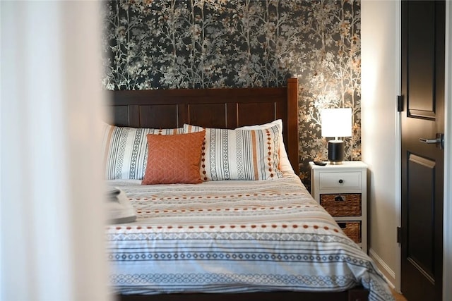 bedroom with wallpapered walls