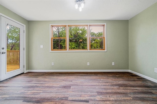 unfurnished room with wood finished floors and baseboards