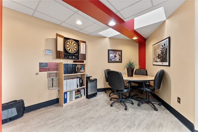 office space with baseboards, a drop ceiling, and recessed lighting