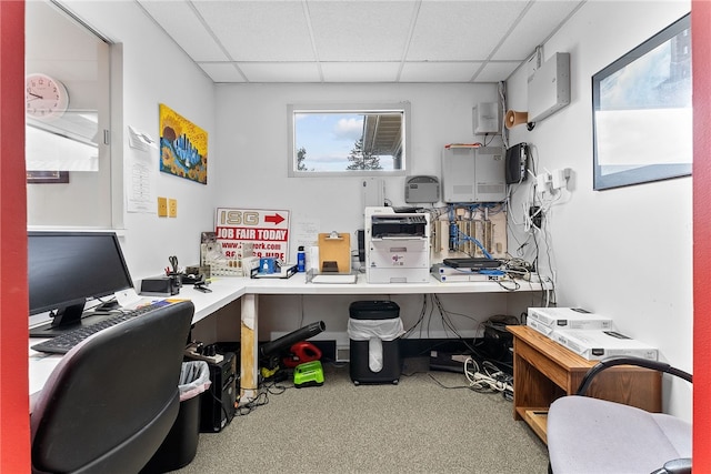 carpeted home office with a drop ceiling