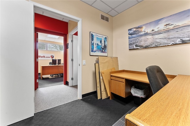 office featuring dark carpet, a drop ceiling, and baseboards
