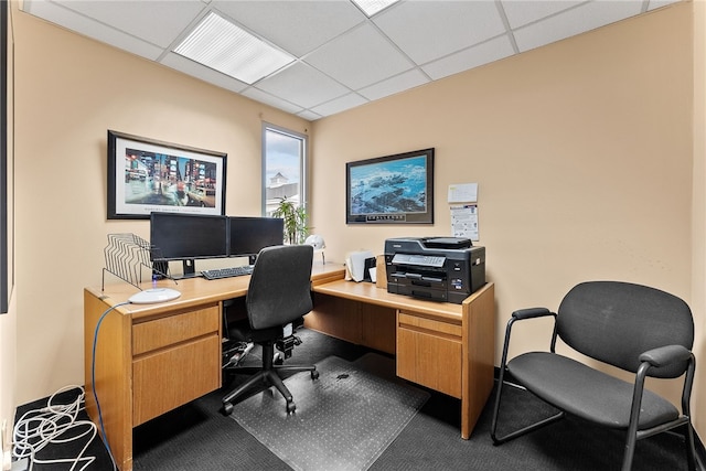 home office with a drop ceiling and dark carpet