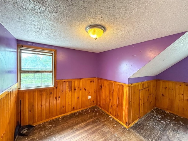 155 Elm St, Saint Clair Twp, PA 15954 - additional living space with wainscoting, a textured ceiling, hardwood / wood-style flooring, and wooden walls