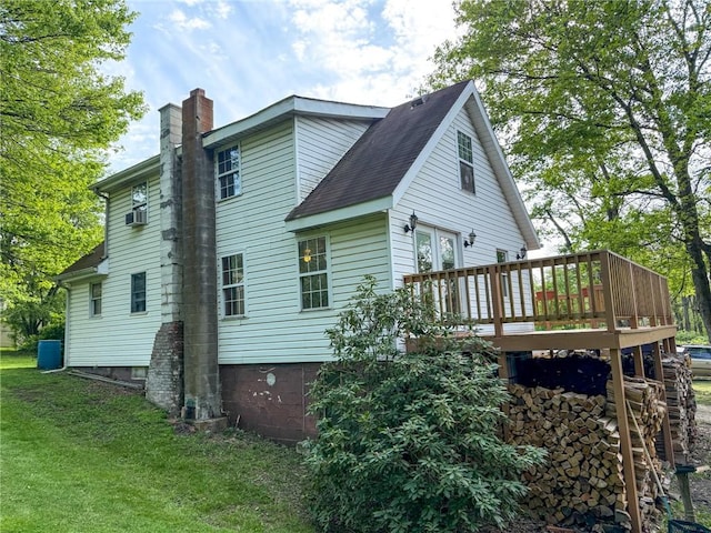 155 Elm St, Saint Clair Twp, PA 15954 - rear view of house featuring a chimney, a deck, a lawn, roof with shingles, and cooling unit