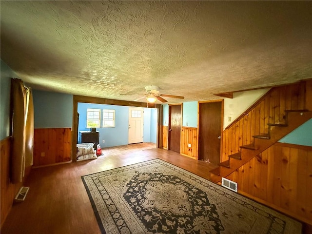 155 Elm St, Saint Clair Twp, PA 15954 - foyer with wooden walls, a textured ceiling, wainscoting, wood finished floors, and stairway