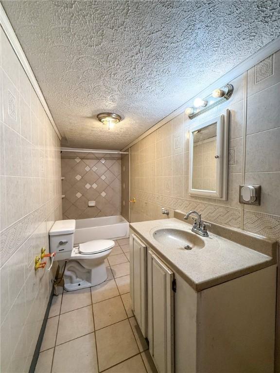 155 Elm St, Saint Clair Twp, PA 15954 - bathroom featuring tile walls, toilet, ornamental molding, a textured ceiling, and vanity