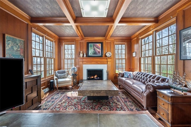 904 Champlain Pl, Adams Twp, PA 15044 - living area with healthy amount of natural light, a warm lit fireplace, ornamental molding, beam ceiling, and a decorative wall