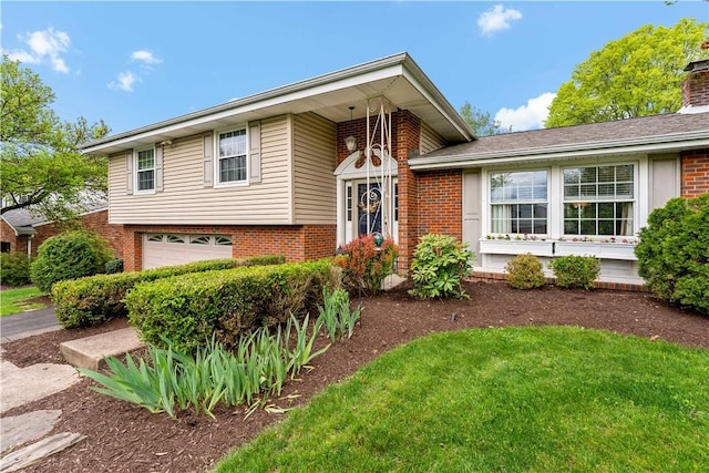 tri-level home with brick siding, an attached garage, and a chimney