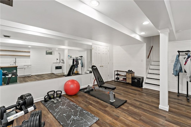 workout room featuring wood finished floors, recessed lighting, and a sink
