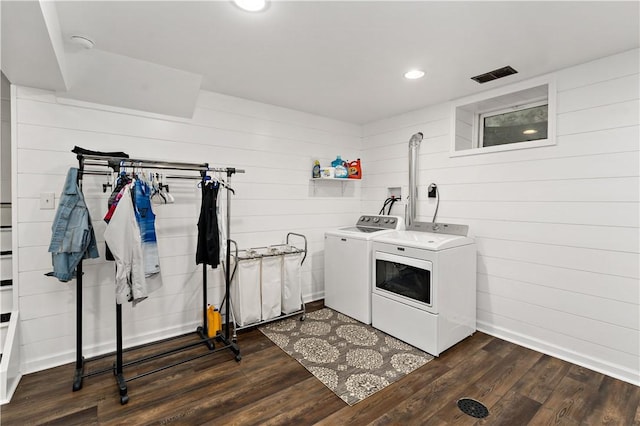 clothes washing area featuring washer and dryer, dark wood finished floors, recessed lighting, wooden walls, and baseboards
