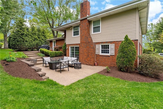 back of property featuring a lawn, a chimney, brick siding, a patio area, and an outdoor hangout area