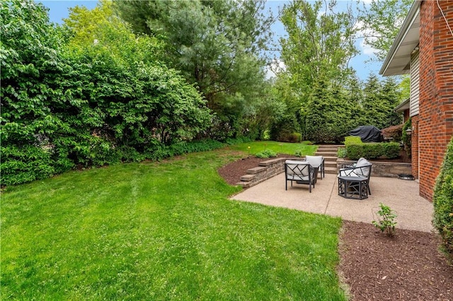 view of green lawn featuring a patio