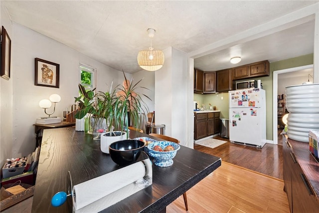 dining space featuring dark wood-style floors