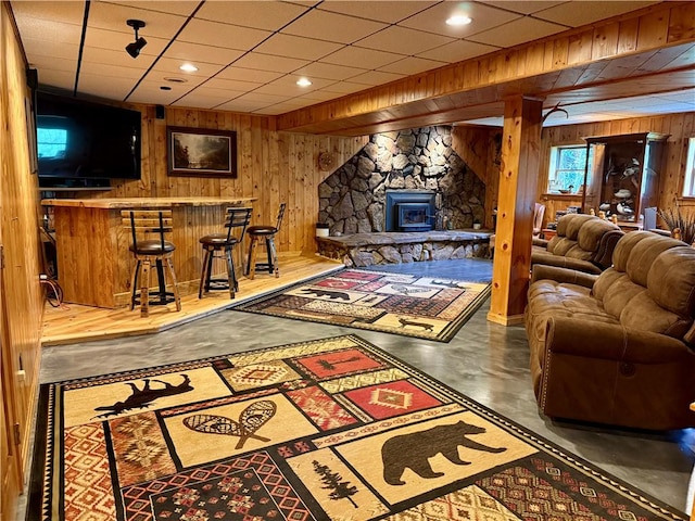 111 Mccall Rd, Franklin Twp But, PA 16001 - living area with wood walls, concrete floors, and a dry bar