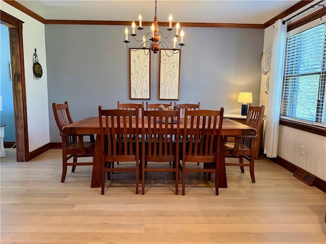 111 Mccall Rd, Franklin Twp But, PA 16001 - dining area with a chandelier, crown molding, light wood-style floors, and baseboards