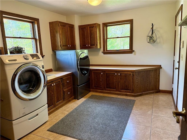 111 Mccall Rd, Franklin Twp But, PA 16001 - clothes washing area featuring cabinet space, healthy amount of natural light, and light tile patterned flooring