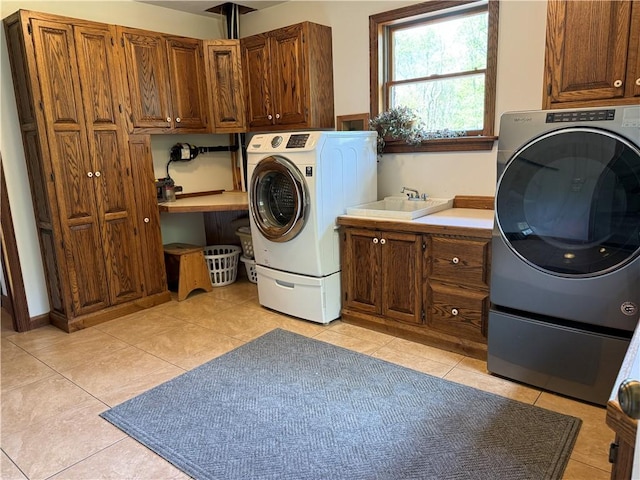 111 Mccall Rd, Franklin Twp But, PA 16001 - laundry area featuring cabinet space, light tile patterned floors, and washer and dryer