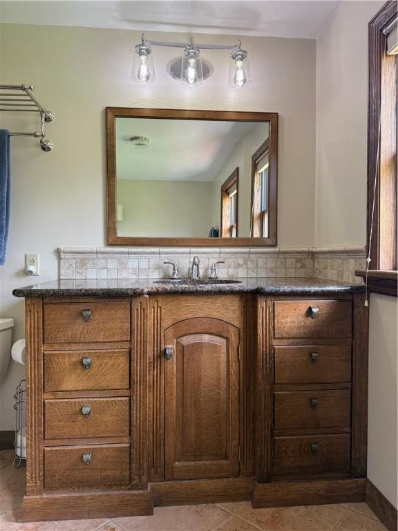 111 Mccall Rd, Franklin Twp But, PA 16001 - bathroom with vanity, toilet, decorative backsplash, and tile patterned floors