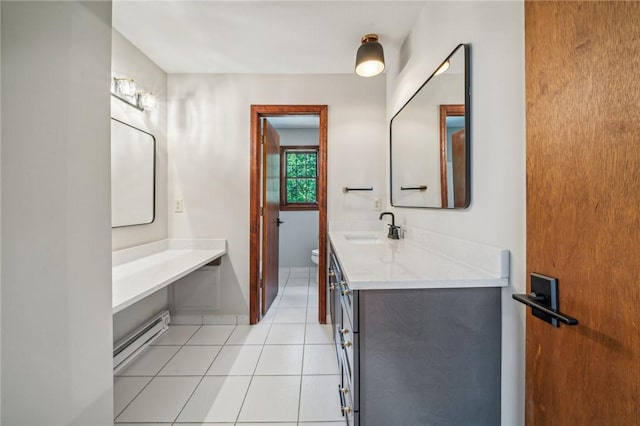 bathroom featuring a baseboard heating unit, toilet, tile patterned floors, and vanity