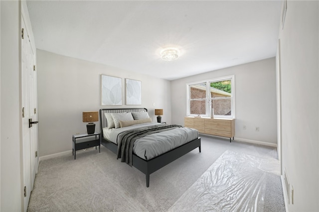 bedroom featuring carpet and baseboards