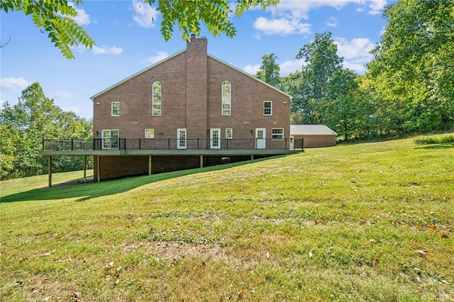 view of side of property with a deck and a yard