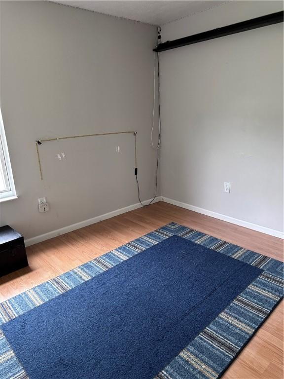 491 Peregrine Dr, North Huntingdon, PA 15642 - empty room featuring wood finished floors and baseboards