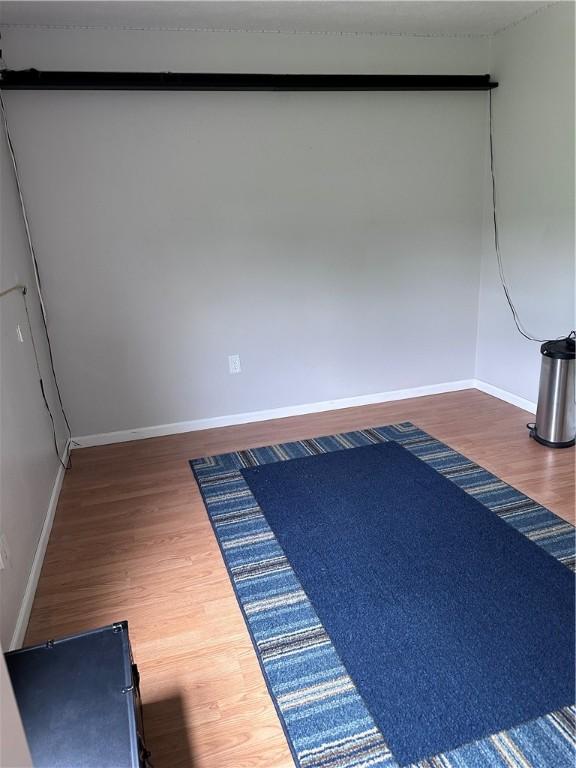 491 Peregrine Dr, North Huntingdon, PA 15642 - empty room with wood finished floors and baseboards