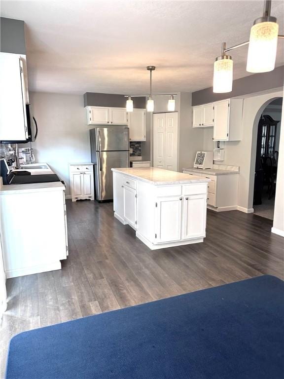 491 Peregrine Dr, North Huntingdon, PA 15642 - kitchen with stainless steel appliances, arched walkways, white cabinetry, and dark wood finished floors