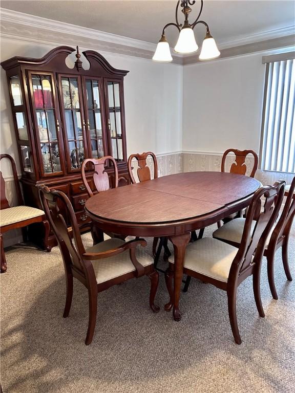 491 Peregrine Dr, North Huntingdon, PA 15642 - dining room featuring light colored carpet, ornamental molding, and a chandelier
