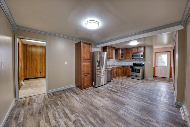710 4th Ave, Ford City Boro, PA 16226 - kitchen with stainless steel appliances, brown cabinets, wood finished floors, ornamental molding, and baseboards