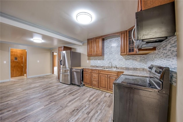 710 4th Ave, Ford City Boro, PA 16226 - kitchen with stainless steel appliances, a sink, brown cabinets, light wood-style flooring, and decorative backsplash