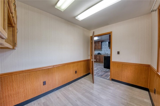 710 4th Ave, Ford City Boro, PA 16226 - unfurnished room featuring a wainscoted wall, light wood-type flooring, wood walls, and wallpapered walls