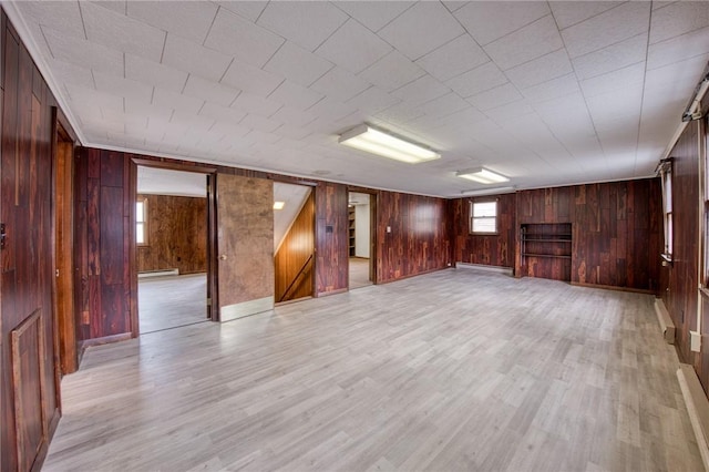 710 4th Ave, Ford City Boro, PA 16226 - below grade area with wood walls, light wood-style floors, a baseboard heating unit, and baseboards