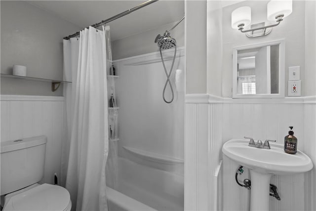 2611 Jane St, South Side, PA 15203 - bathroom featuring a wainscoted wall, toilet, and shower / bath combination with curtain