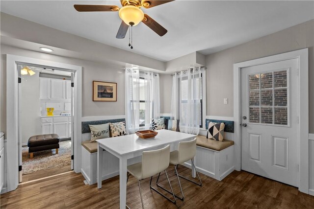 2611 Jane St, South Side, PA 15203 - dining area featuring dark wood finished floors, wainscoting, and a ceiling fan