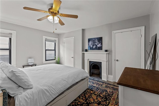 2611 Jane St, South Side, PA 15203 - bedroom featuring a fireplace with flush hearth, wood finished floors, ceiling fan, and baseboards