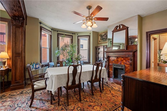 209 Bon Air Ave, Bon Air, PA 15210 - dining room with a ceiling fan, wood finished floors, and a fireplace