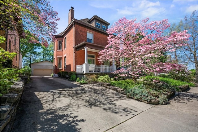 209 Bon Air Ave, Bon Air, PA 15210 - view of front of home featuring a garage, an outbuilding, a chimney, and brick siding