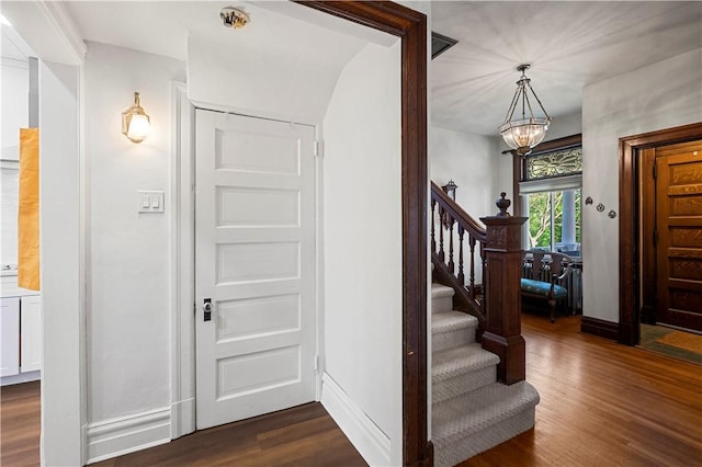 209 Bon Air Ave, Bon Air, PA 15210 - foyer entrance with a chandelier, stairs, and dark wood-style floors