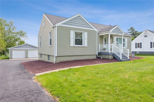 view of front of property with a garage, an outdoor structure, and a front lawn