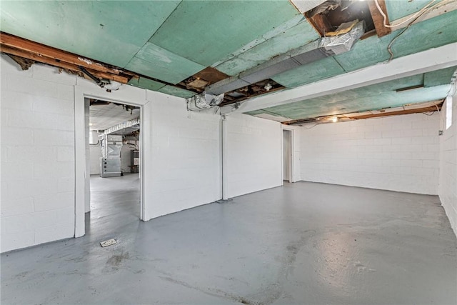 unfinished below grade area with heating unit and concrete block wall